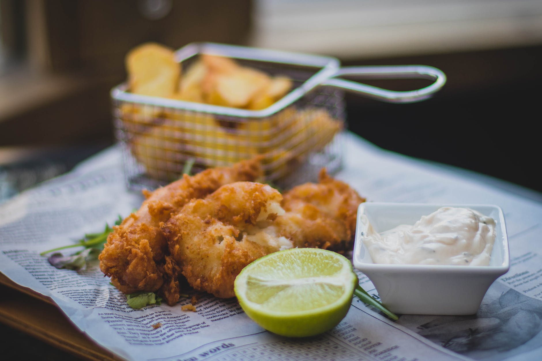 fried meat beside sliced lemon and white mustard